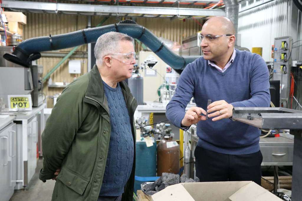 Mr Ramon Atayde from ARC Ento Tech and Dr Arash Tahmasebi standing with the coke oven at NIER, the University of Newcastle.