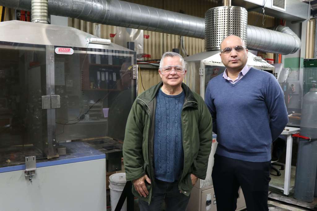 Mr Ramon Atayde from ARC Ento Tech and Dr Arash Tahmasebi standing with the coke oven at NIER, the University of Newcastle.
