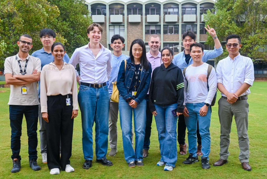 The HDR cohort standing together and smiling.